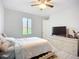 Light and airy bedroom featuring a ceiling fan, and a large window with exterior view at 11960 De Leon Dr, North Port, FL 34287