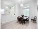 Dining area features modern lighting fixture, wood-look floors, bright natural light and neutral decor at 11960 De Leon Dr, North Port, FL 34287