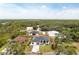 Aerial view showcases a modern home with a well-maintained lawn, landscaping and a paved driveway at 11960 De Leon Dr, North Port, FL 34287