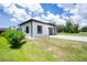 A sunny view of this beautifully constructed home and well manicured lawn with a driveway and one car garage at 11960 De Leon Dr, North Port, FL 34287