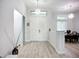 Bright foyer with high ceilings, wood-look floors, and an eye-catching light fixture at 11960 De Leon Dr, North Port, FL 34287