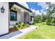 A view of this home's front yard shows its beautiful walkway and tasteful landscaping around its entryway at 11960 De Leon Dr, North Port, FL 34287