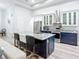 Bright, open-concept kitchen with granite counters, a kitchen island, stainless appliances, and an eat-in bar at 11960 De Leon Dr, North Port, FL 34287