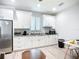 This kitchen features white cabinets, stainless steel appliances, and granite countertops offering a clean and stylish design at 11960 De Leon Dr, North Port, FL 34287
