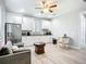 Charming kitchen with white cabinets, modern appliances, and an adjacent living space at 11960 De Leon Dr, North Port, FL 34287