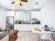 Well-lit kitchen with white cabinetry, stainless appliances, and a cozy dining area at 11960 De Leon Dr, North Port, FL 34287