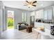 Bright kitchen with white cabinets, stainless steel appliances, and an exit to the backyard at 11960 De Leon Dr, North Port, FL 34287