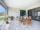 Lanai featuring brick flooring, outdoor dining set, and sliding glass door access to the interior at 11960 De Leon Dr, North Port, FL 34287