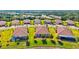 Aerial view showcases houses with lush landscaping and manicured lawns in desirable neighborhood at 12230 Amica Loop, Venice, FL 34293