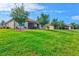 Expansive backyard features lush green lawn and mature trees, perfect for outdoor activities at 12230 Amica Loop, Venice, FL 34293