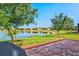 Paver patio area features a lake view, perfect for outdoor dining and entertaining with a grill at 12230 Amica Loop, Venice, FL 34293