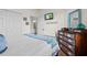 Bedroom featuring a dresser with vintage accents, a queen bed, and a TV mounted on the wall at 12230 Amica Loop, Venice, FL 34293