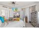 Serene bedroom providing seamless views into living area, offering a harmonious blend of style and functionality at 12230 Amica Loop, Venice, FL 34293