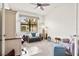 Cozy bedroom with plush seating, a ceiling fan, and a bright window offering a pleasant view at 12230 Amica Loop, Venice, FL 34293