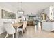 Open-concept dining room flowing into the living room, perfect for entertaining guests at 12230 Amica Loop, Venice, FL 34293