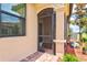 Inviting front entrance with screened porch, decorative columns and attractive brick walkway at 12230 Amica Loop, Venice, FL 34293