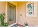 Stylish front door and modern exterior wall decor enhancing curb appeal at 12230 Amica Loop, Venice, FL 34293