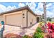 Exterior shot of the house highlighting the brick walkway and landscaping at 12230 Amica Loop, Venice, FL 34293