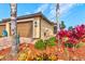 Charming single-story home featuring a terracotta roof, paver driveway, two car garage and beautifully landscaped front yard at 12230 Amica Loop, Venice, FL 34293