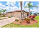Beautiful exterior view of home with a paver driveway and well-maintained landscaping at 12230 Amica Loop, Venice, FL 34293