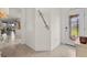 Bright foyer features tile flooring and a decorative door, leading to other rooms in the home at 12230 Amica Loop, Venice, FL 34293