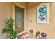 Charming front entrance with a decorative glass door, brick flooring, and beautiful decorations at 12230 Amica Loop, Venice, FL 34293