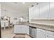 Stylish kitchen with stainless-steel appliances, and granite countertops seamlessly opening to the adjacent dining area at 12230 Amica Loop, Venice, FL 34293