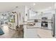 Modern kitchen features granite countertops, stainless steel appliances, and ample cabinet space at 12230 Amica Loop, Venice, FL 34293