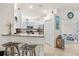 Well-lit kitchen area featuring granite counters, stainless steel appliances, and barstool seating at 12230 Amica Loop, Venice, FL 34293