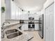 Bright kitchen featuring granite countertops, stainless appliances, and ample cabinet space for storage at 12230 Amica Loop, Venice, FL 34293