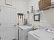 Laundry room features a washer, a dryer, shelving, decor, and a nearby doorway at 12230 Amica Loop, Venice, FL 34293