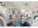 Cozy living room with stylish built-ins and comfortable seating overlooking the kitchen at 12230 Amica Loop, Venice, FL 34293