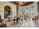 Spacious lounge area with comfortable seating, large windows, and views of the pool area at 12230 Amica Loop, Venice, FL 34293