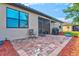Cozy brick patio with a chair and grill, perfect for outdoor dining and relaxation at 12230 Amica Loop, Venice, FL 34293
