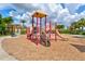 Community playground with colorful play equipment, slides, and a wood chip ground at 12230 Amica Loop, Venice, FL 34293