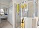 Walk in shower with glass doors, tiled surround, and adjacent closet and doorway leading to the main bedroom at 12230 Amica Loop, Venice, FL 34293