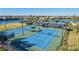 Bright, blue tennis courts sit adjacent to the lake in this beautiful residential community at 12230 Amica Loop, Venice, FL 34293