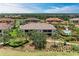 Aerial shot of a multi-Gathering home, set amidst lush landscaping and serene pond views at 13711 Messina Loop # 102, Lakewood Ranch, FL 34211