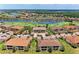 Overhead view of property near green, lake, and other homes at 13711 Messina Loop # 102, Lakewood Ranch, FL 34211