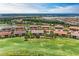 Aerial view showcasing a well-manicured community with a serene lake at 13711 Messina Loop # 102, Lakewood Ranch, FL 34211