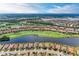 Stunning aerial view of a golf course community, featuring homes, lakes, and lush green fairways under a sunny sky at 13711 Messina Loop # 102, Lakewood Ranch, FL 34211