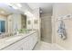Bright bathroom with double sinks, granite counters and a shower at 13711 Messina Loop # 102, Lakewood Ranch, FL 34211