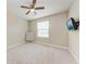 Bright, empty bedroom with a ceiling fan and mounted television at 13711 Messina Loop # 102, Lakewood Ranch, FL 34211