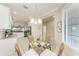 Bright dining nook with views into the kitchen with stainless appliances and white cabinets at 13711 Messina Loop # 102, Lakewood Ranch, FL 34211