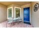 Cozy front porch with chairs, windows, a blue front door, and decorative signage at 13711 Messina Loop # 102, Lakewood Ranch, FL 34211