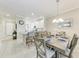 Kitchen and dining area featuring an island with seating, white cabinets, and tile flooring at 13711 Messina Loop # 102, Lakewood Ranch, FL 34211
