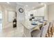Kitchen view highlighting white cabinetry, granite countertops, and bar seating with a breakfast bar at 13711 Messina Loop # 102, Lakewood Ranch, FL 34211