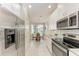 Modern kitchen featuring stainless steel appliances, white cabinets, and a cozy breakfast nook at 13711 Messina Loop # 102, Lakewood Ranch, FL 34211
