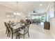 Open-concept living and dining area featuring a cozy living room and an adjacent dining area at 13711 Messina Loop # 102, Lakewood Ranch, FL 34211