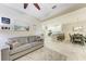 Open concept living space with a couch, kitchen and dining area at 13711 Messina Loop # 102, Lakewood Ranch, FL 34211